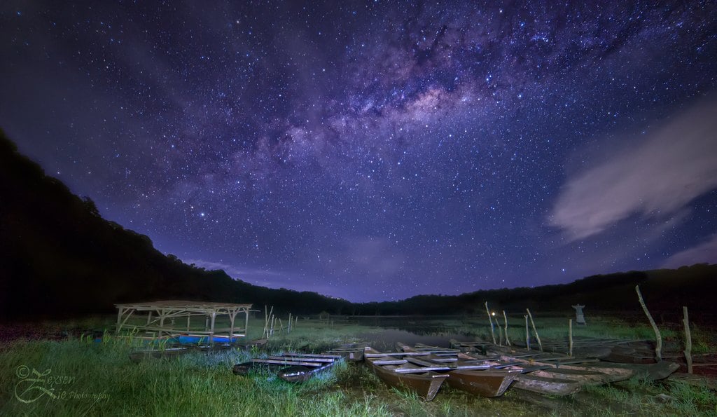 The Milky Way above a dark valley