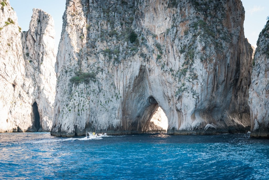 Pale cliffs with sea caves above clear blue water