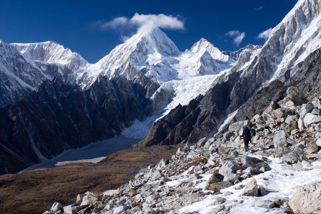 Snow-covered peaks above a rocky moraine